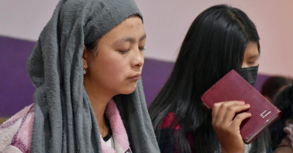 Youth from Myanmar in prayer and giving thanks for the Bibles they have received