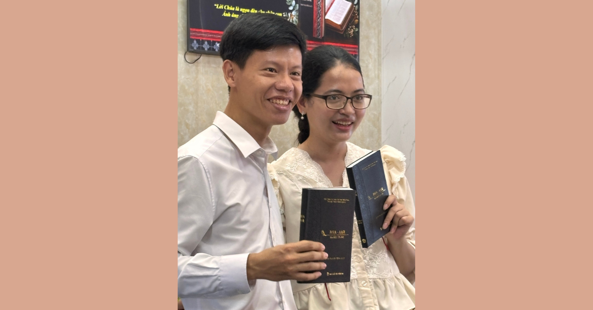 Believers in Vietnam hold the newly printed New Testaments